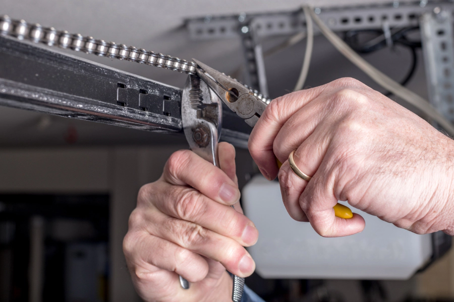 person repairing garage door chains houston tx